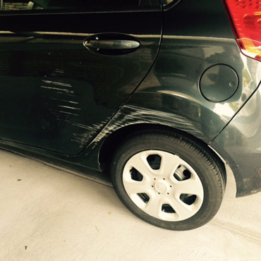 black car with scratch at repairing